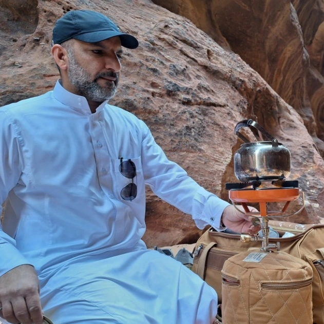 Fawaz Al Fageer brewing tea in a sandstone canyon